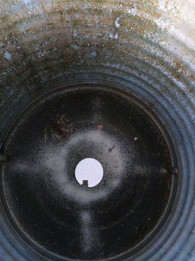 Tank interior full of sludge before cleaning