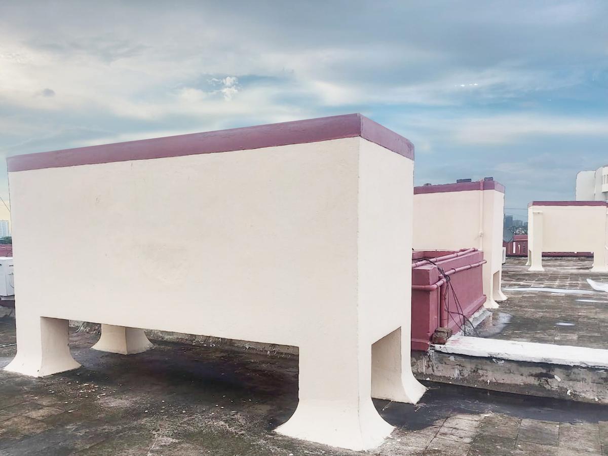 Overhead water tanks on an apartment rooftop in Kolkata